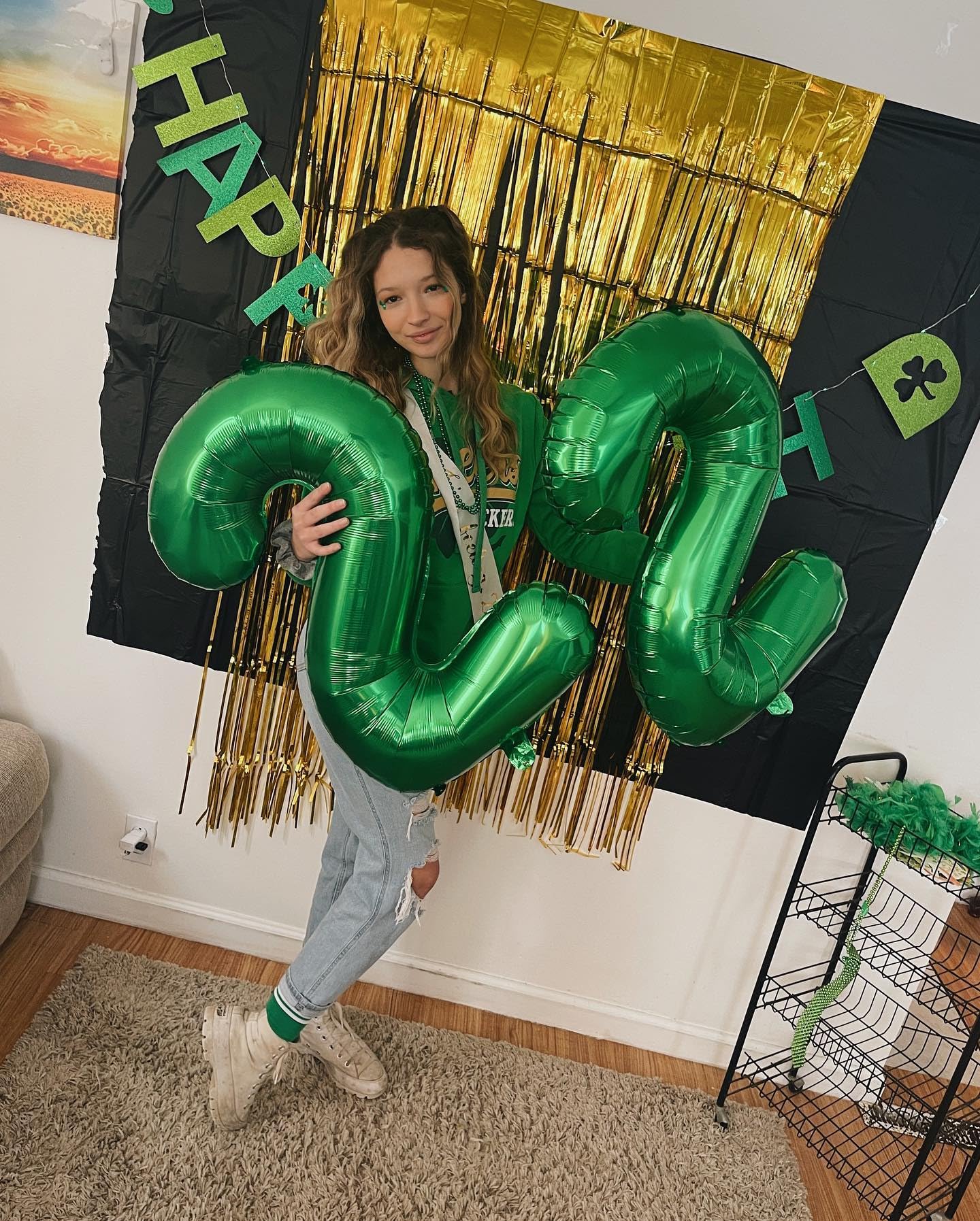 IWERP green 21-balloon stage backdrop enhances party ambiance.