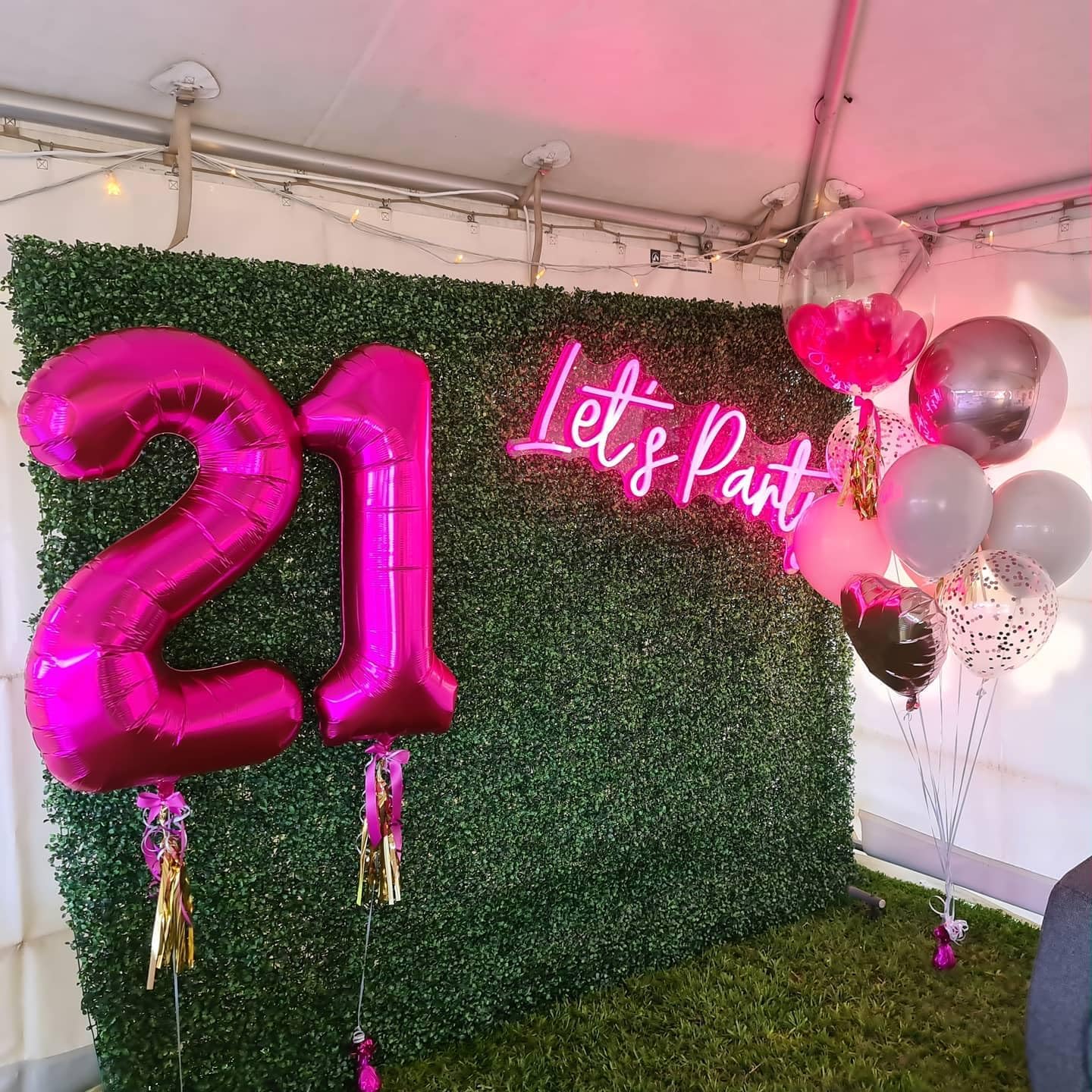 IWERP hot pink foil balloon backdrops offer a glamorous focal point.