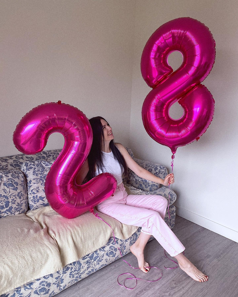 IWERP hot pink number 8 balloon arrangement enhances festive decor.