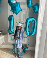 IWERP blue 0 number balloon in a festive party setup with other decor.