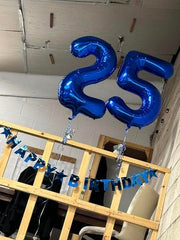 IWERP photo backdrop featuring blue 25th balloon elevates party snapshots.