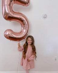 IWERP rose-gold foil number balloon stands out as a striking focal point.