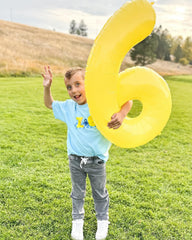 IWERP Yellow 0 Balloon 40 Inch forms a stage backdrop for photos.