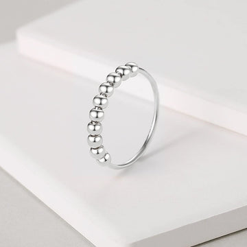 Jacruces sterling silver fidget ring for women with minimalist bead design.