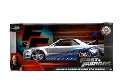 Side profile of Brian’s Skyline R34 highlights the sleek silver-blue finish for collectors.