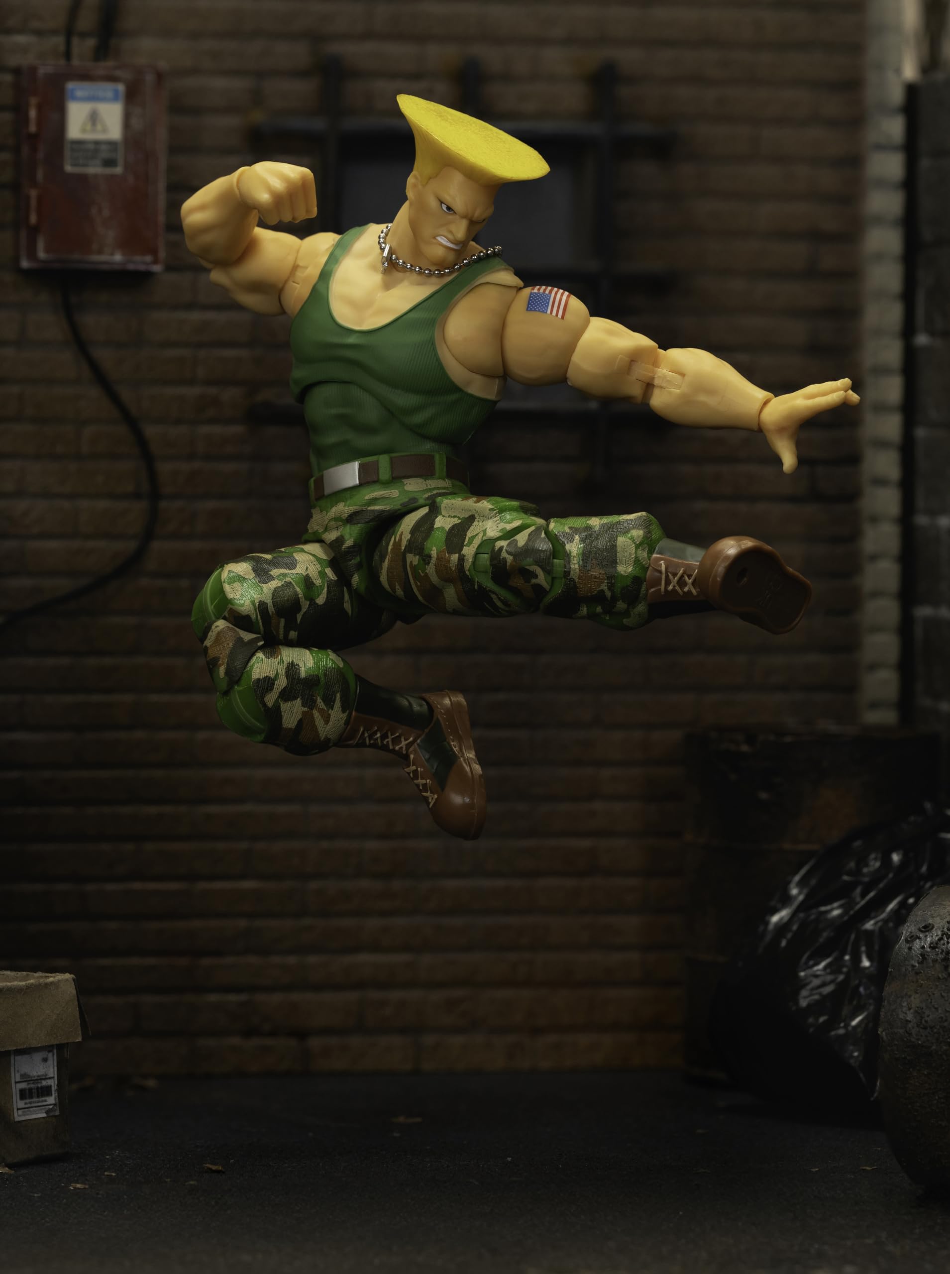 Jada Guile action figure in battle-ready pose on shelf.