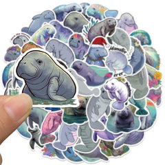 Jaurney Manatee stickers on a laptop with waterproof finish.