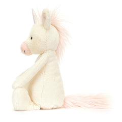 Jellycat Bashful Unicorn Little in hand, showing compact, travel-friendly size for on-the-go hugs.