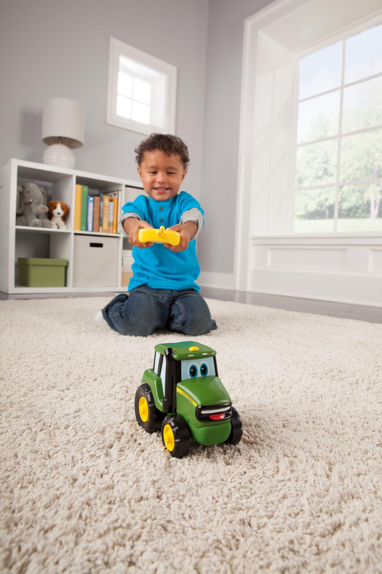 John Deere Johnny Tractor RC toy with remote, simple two-button controller.