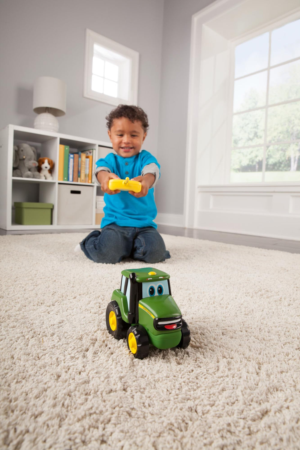 John Deere Johnny Tractor RC toy with remote, simple two-button controller.