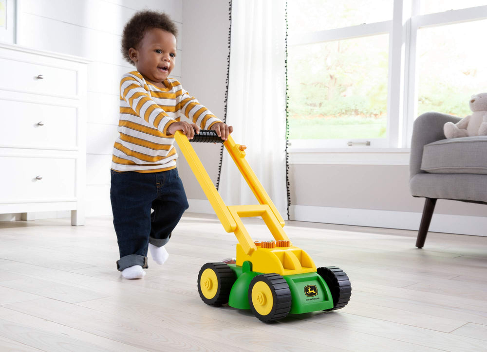 John Deere Tomy lawn mower buttons emit unique sounds to engage kids.