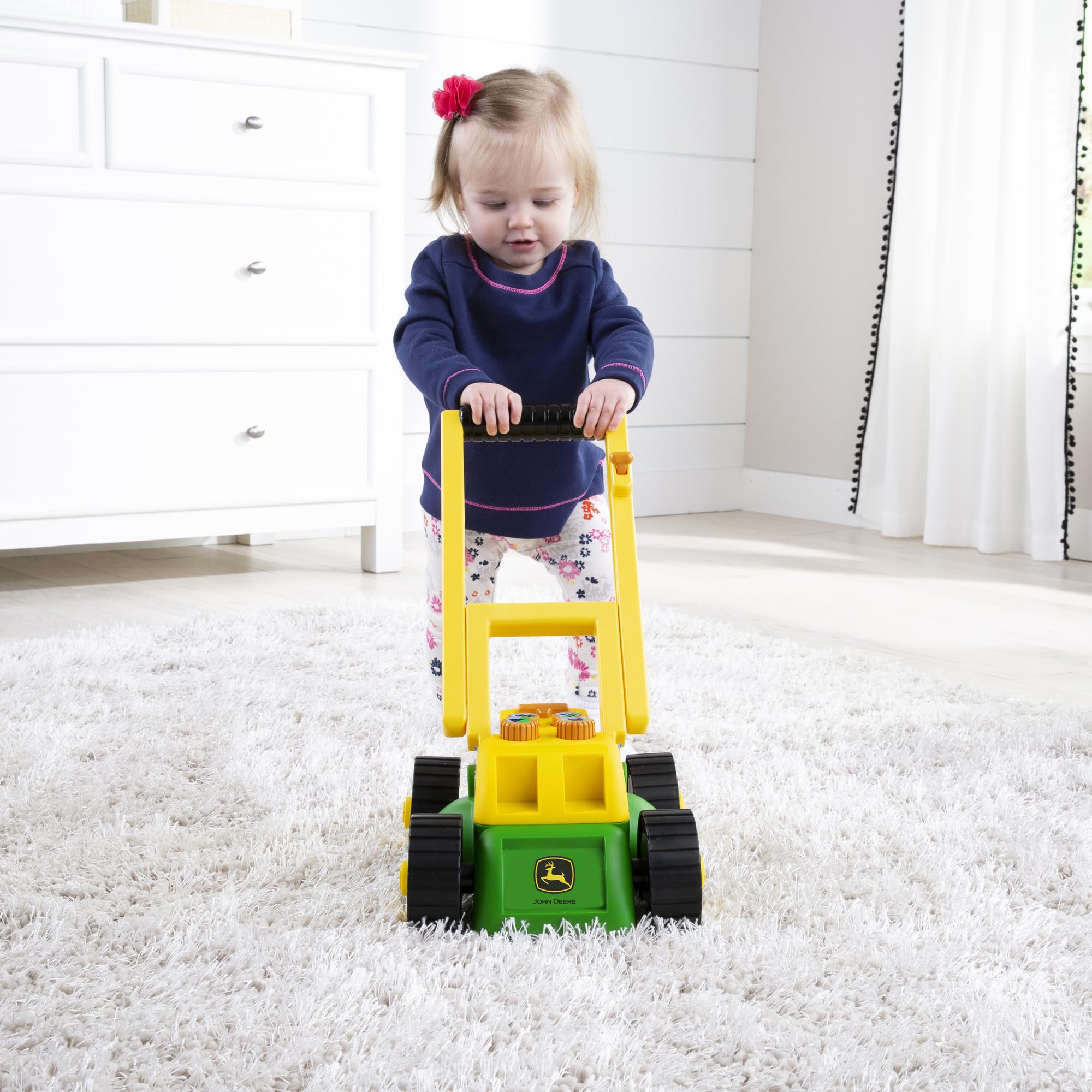 John Deere Tomy lawn mower folded handle stores compactly after play.