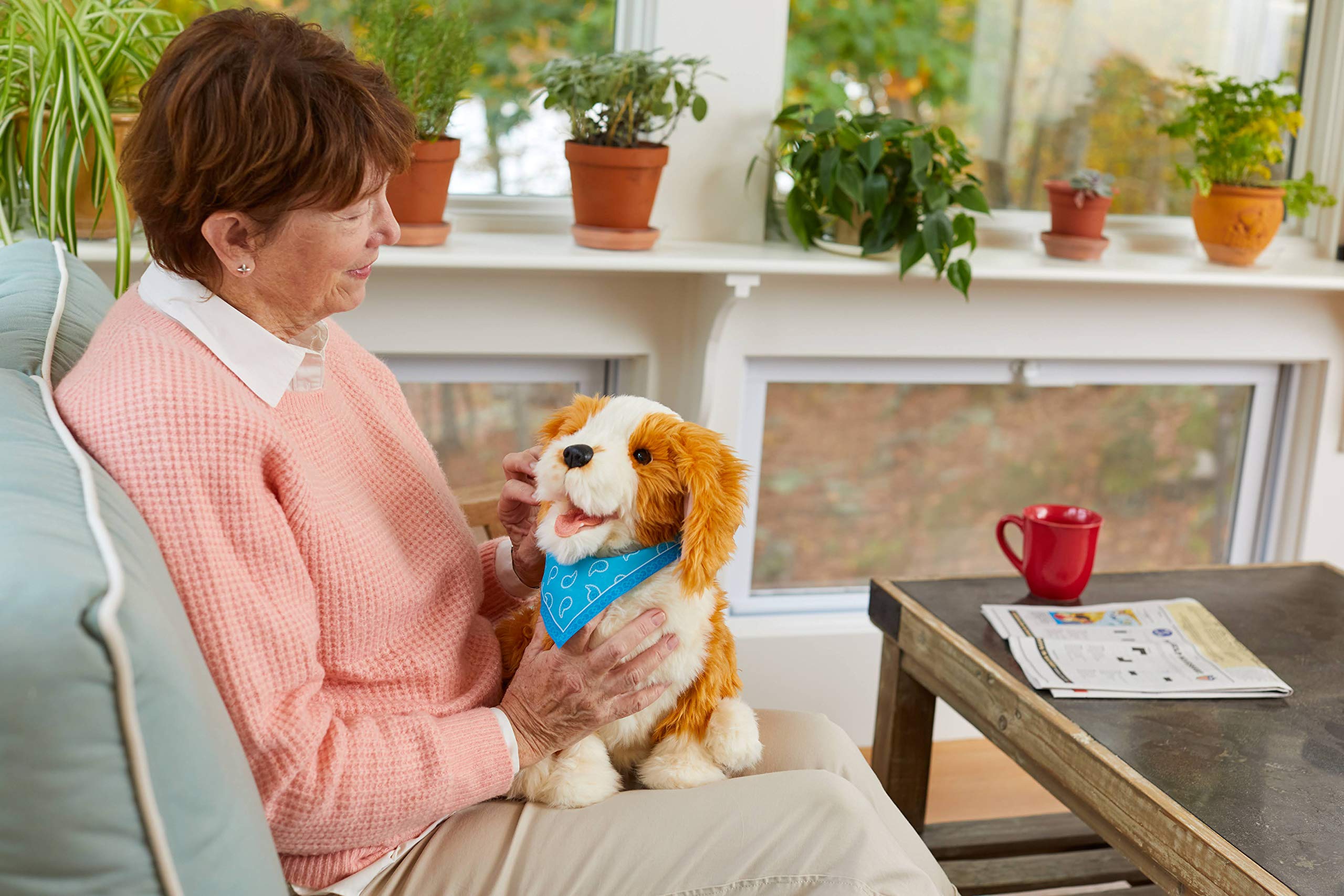 Joy for All Freckled Pup interaction shot shows BarkBack sounds and heartbeat response for engaging play