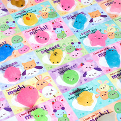 JOYIN glitter Mochi squishy toy shown with a colorful Valentines card for classroom exchange