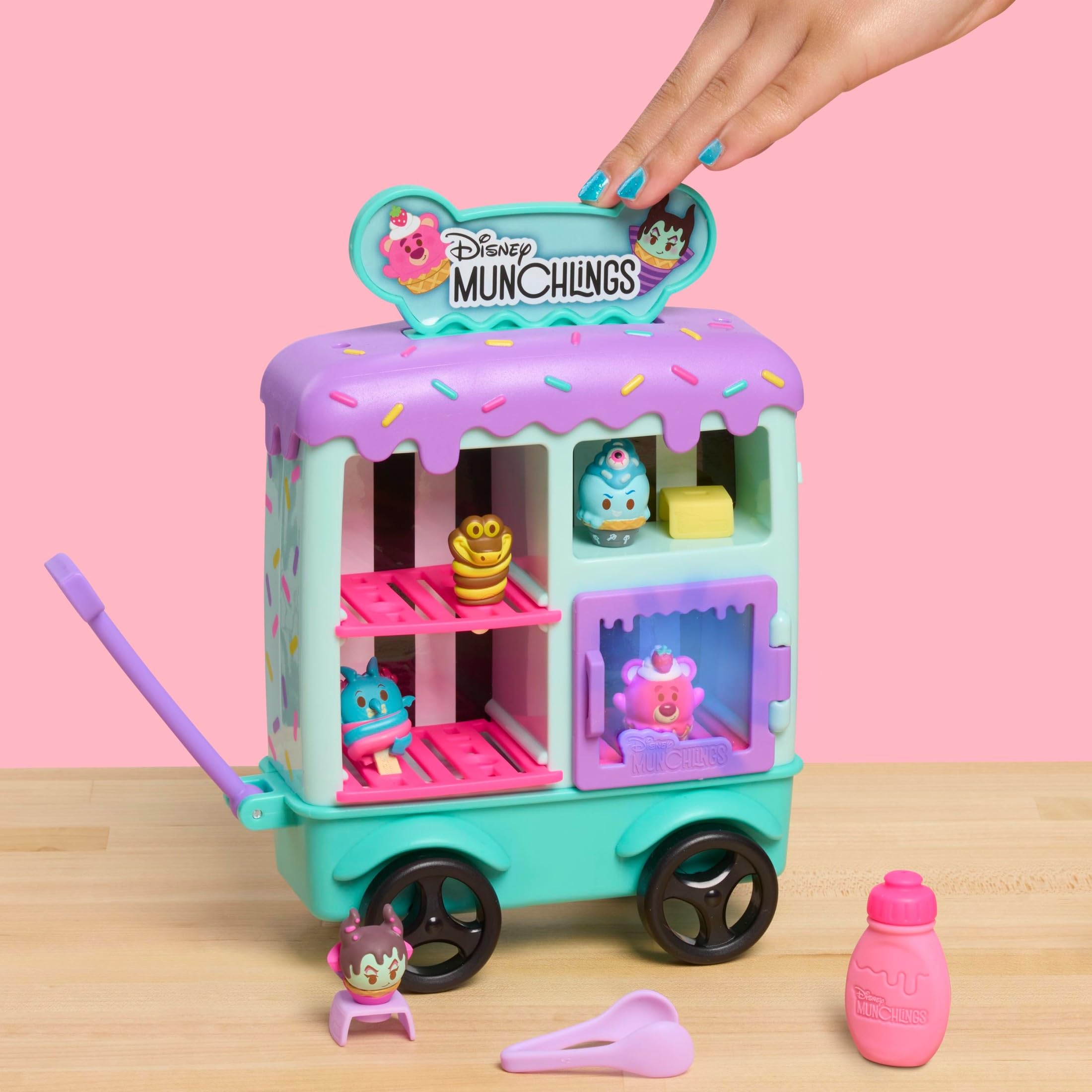 Just Play Disney Munchlings Ice Cream Cart side view shows included accessories for pretend scooping
