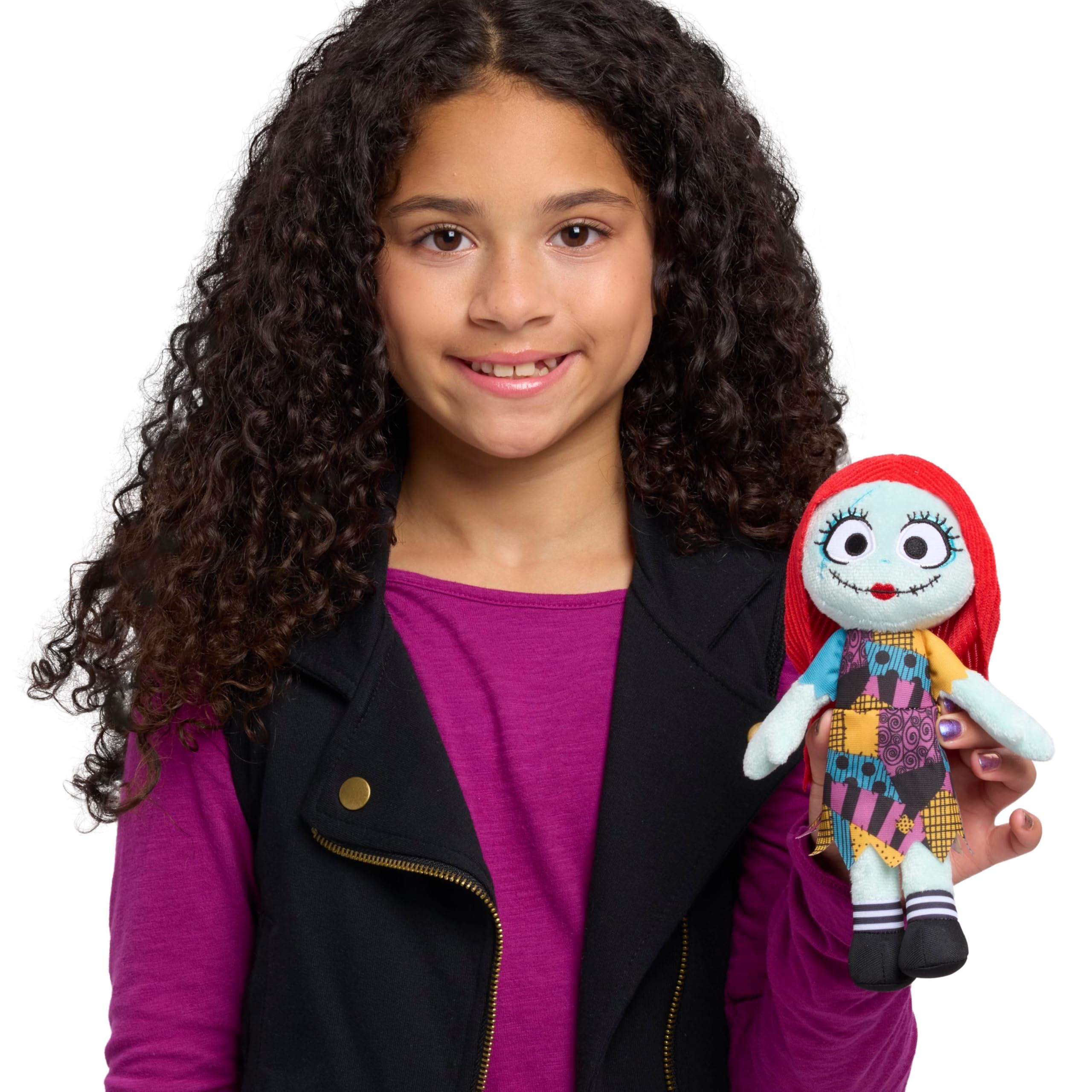 Just Play Sally plush close-up shows embroidered features and patchwork dress