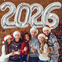 KALOR 2026 silver foil number balloons used as a festive photo backdrop.