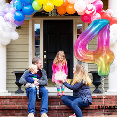 KatchOn rainbow 4-balloon backdrop creates colorful party ambiance.