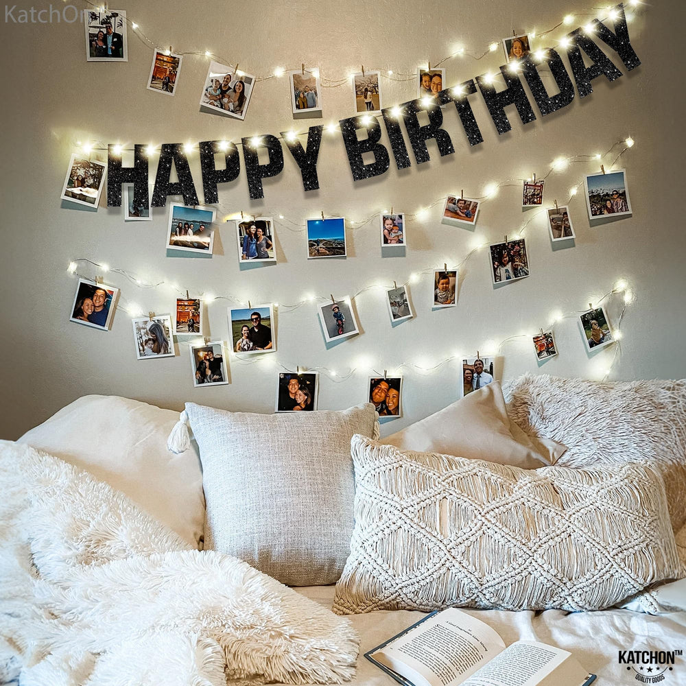 KatchOn backdrop pairs with balloons for cohesive black-themed party décor.