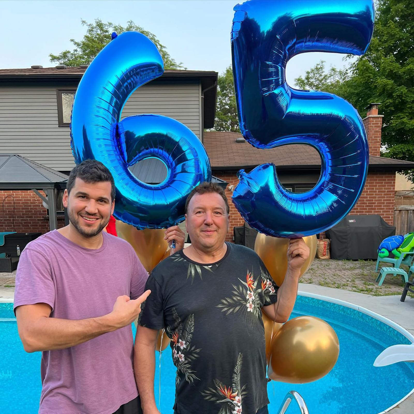 Kelfuoya birthday backdrop with navy blue 9 balloon and decor.