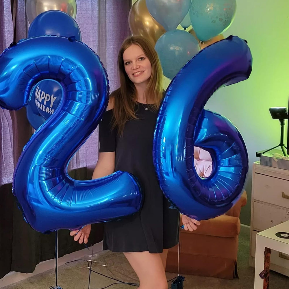 Kelfuoya birthday party setup with navy blue 26 balloon centerpiece