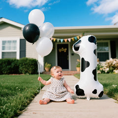 Kelfuoya cow-print number 1 balloon hung on wall for elegant backdrop.