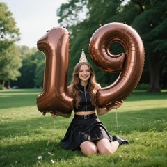 Kelfuoya dark brown foil number balloon mounted on wall adds elegant milestone ambiance.