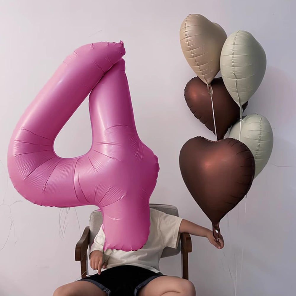 Kelfuoya party decor setup with pink 14 balloon centerpiece.
