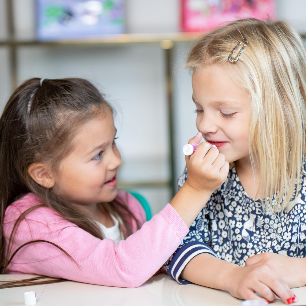 Child applies Luna Star makeup during pretend play