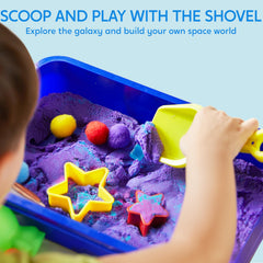 Klever Kits toddler plays with sand to build space scenes.