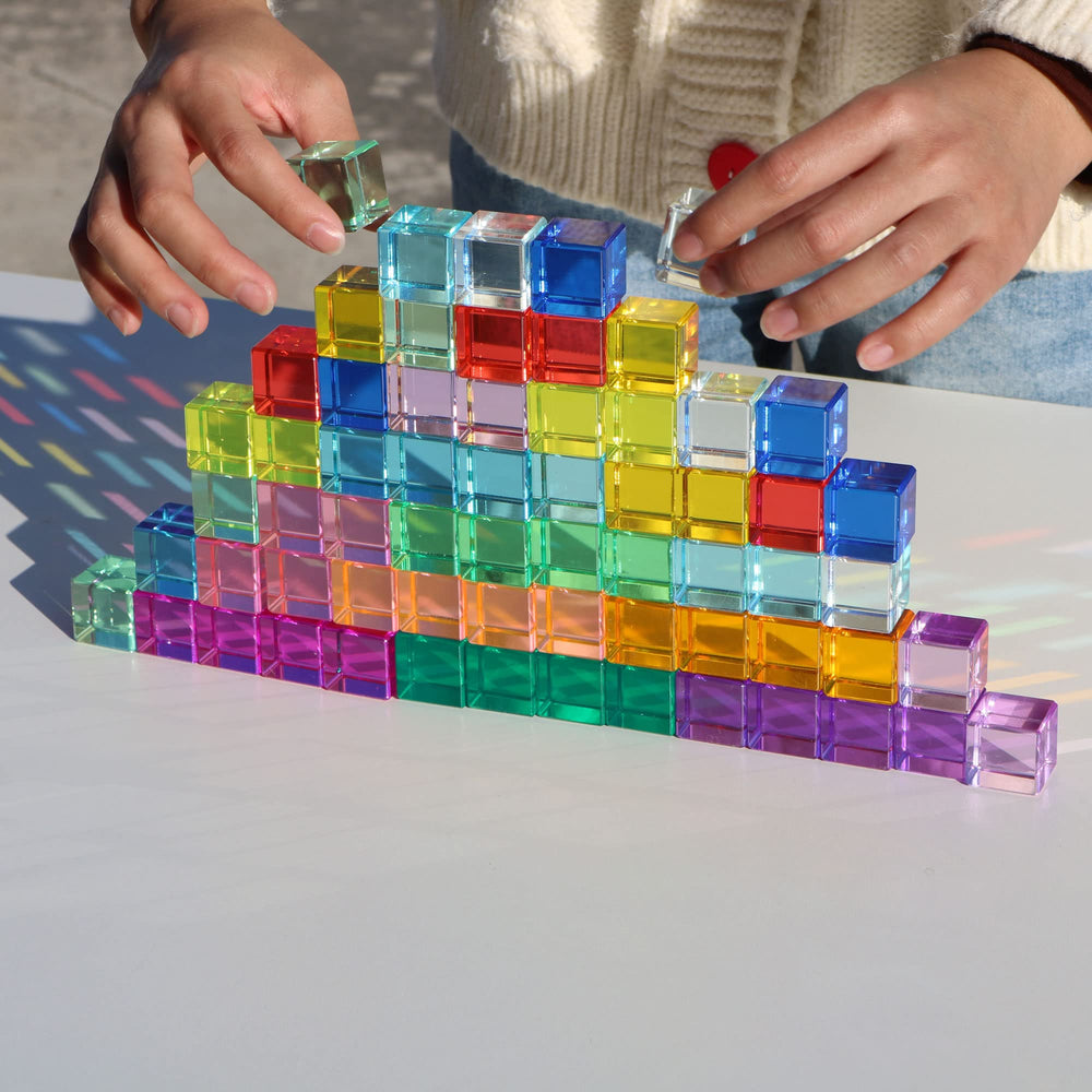 KOAICS Rainbow Crystal Cubes beside beech wood house for enhanced play pairing.