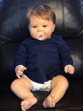 KOKOMANDY 24-inch reborn doll face close-up showing warm, lifelike features for cuddling