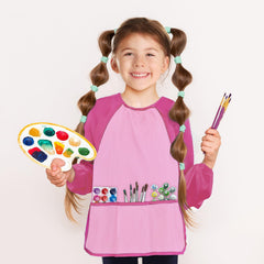Kopokita pink smock on child demonstrates roomy size for ages 2-6.