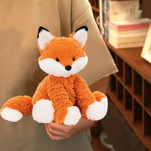 KUUDESOXX orange fox plush sits on a bed adding warmth to the room.