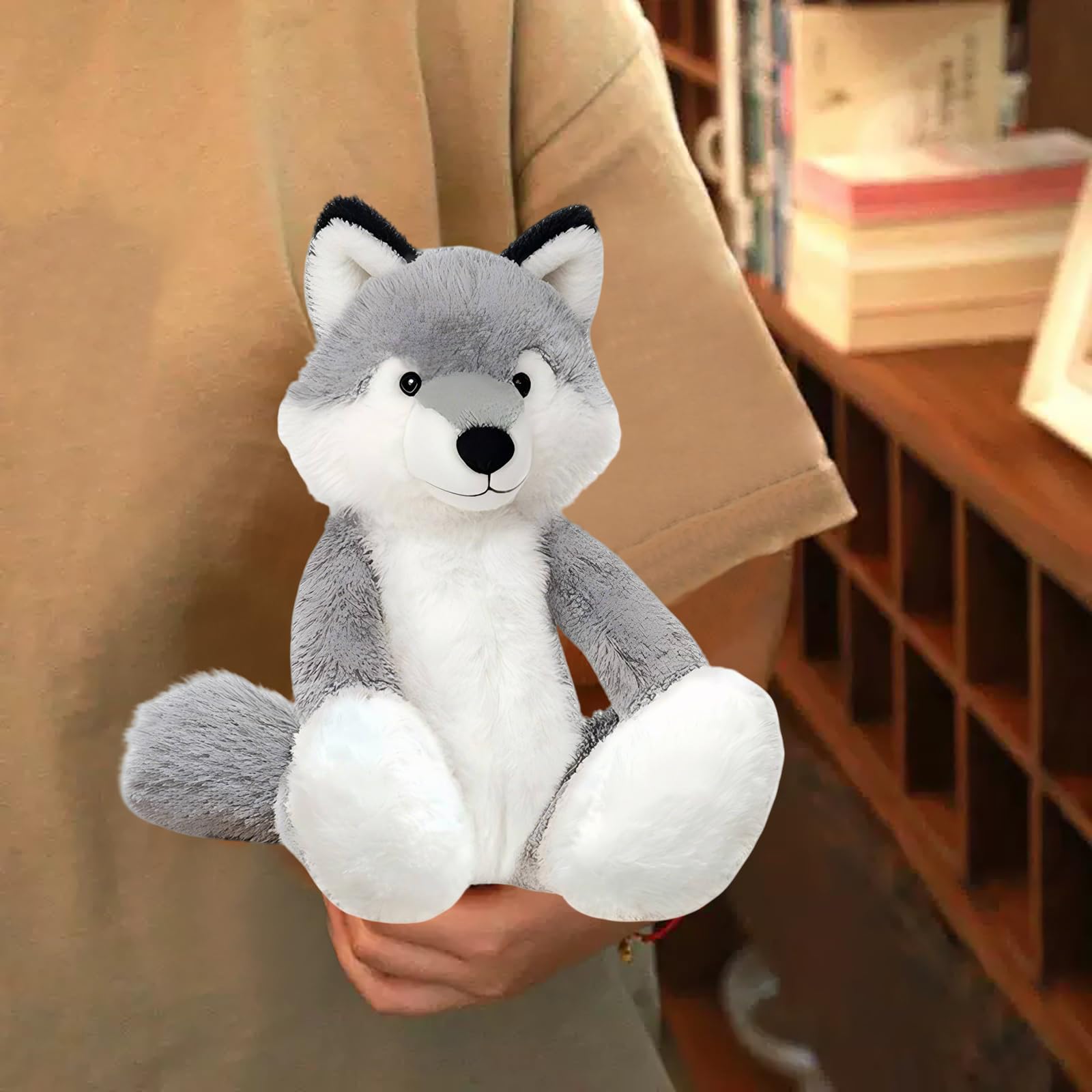 KUUDESOXX Wolf Stuffed Animal resting on a bed adds cozy room decor.