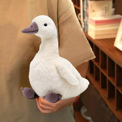 KUUDESOXX duck plush on bed enhances cozy decor and comfort.