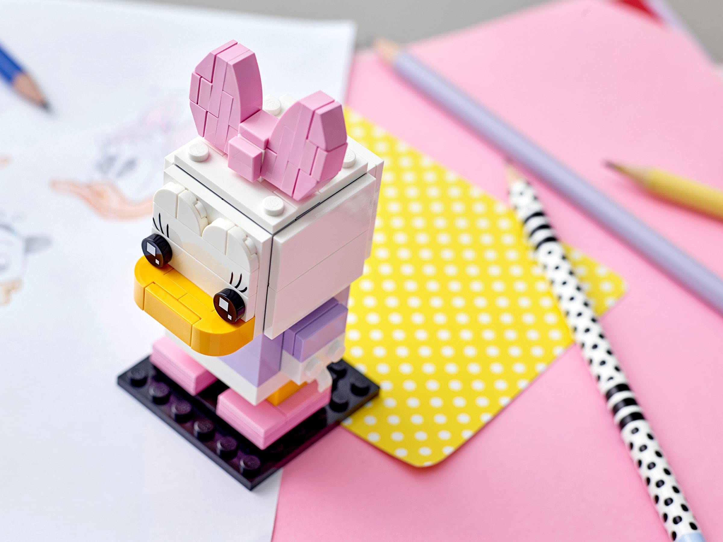 Daisy Duck BrickHeadz on display, ready to brighten a desk or shelf.