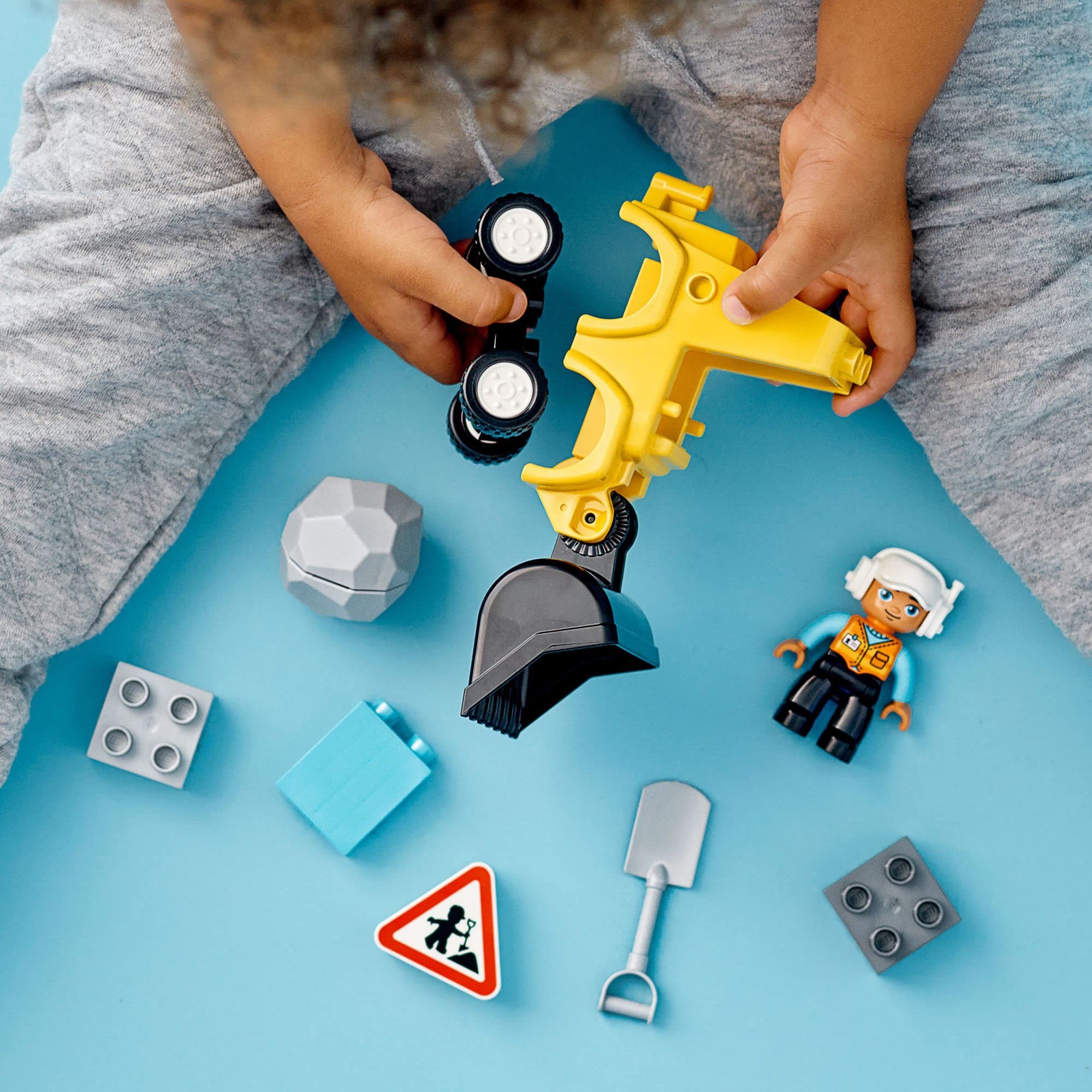 LEGO DUPLO construction worker figure in hi-visibility vest enhances role-play realism.