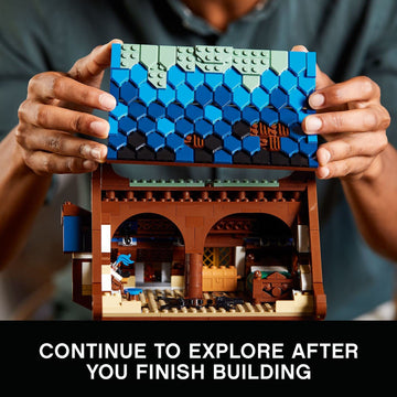 LEGO Ideas Medieval Blacksmith 21325 garden with apple tree and well, adds outdoor charm.