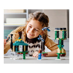 LEGO Minecraft Sky Tower orange tabby cat companion amid curious builds.