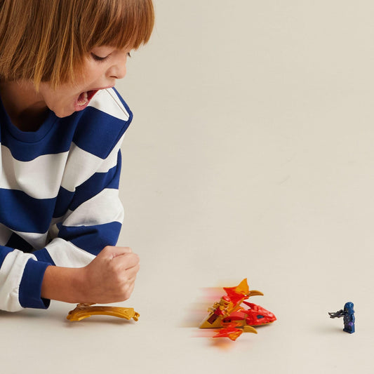LEGO NINJAGO dragon tail slam action photo showing Kai and dragon in motion for kids.
