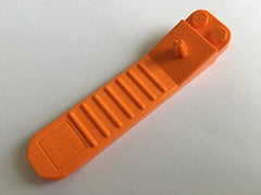 LEGO orange brick and axle separator tool side view, ergonomic grip reduces effort.