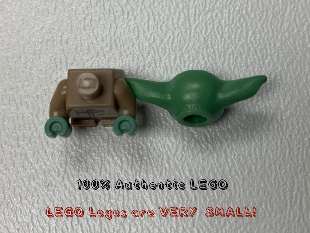 Tiny LEGO Grogu minifigure beside Minifigureland tile for display