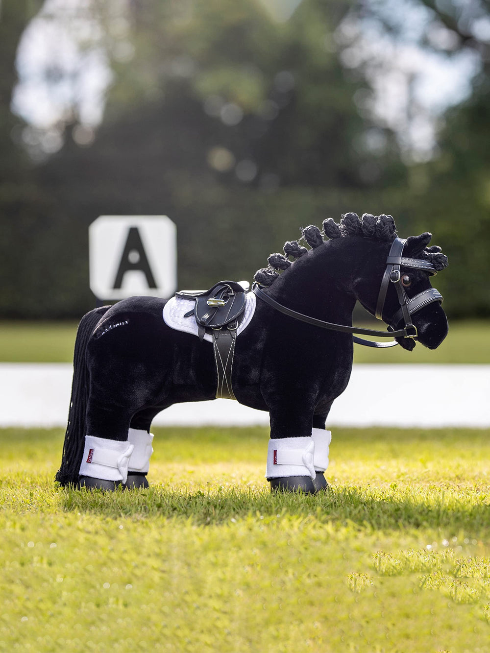 LeMieux Toy Pony Saddle features detachable girth and metal stirrups for practice.