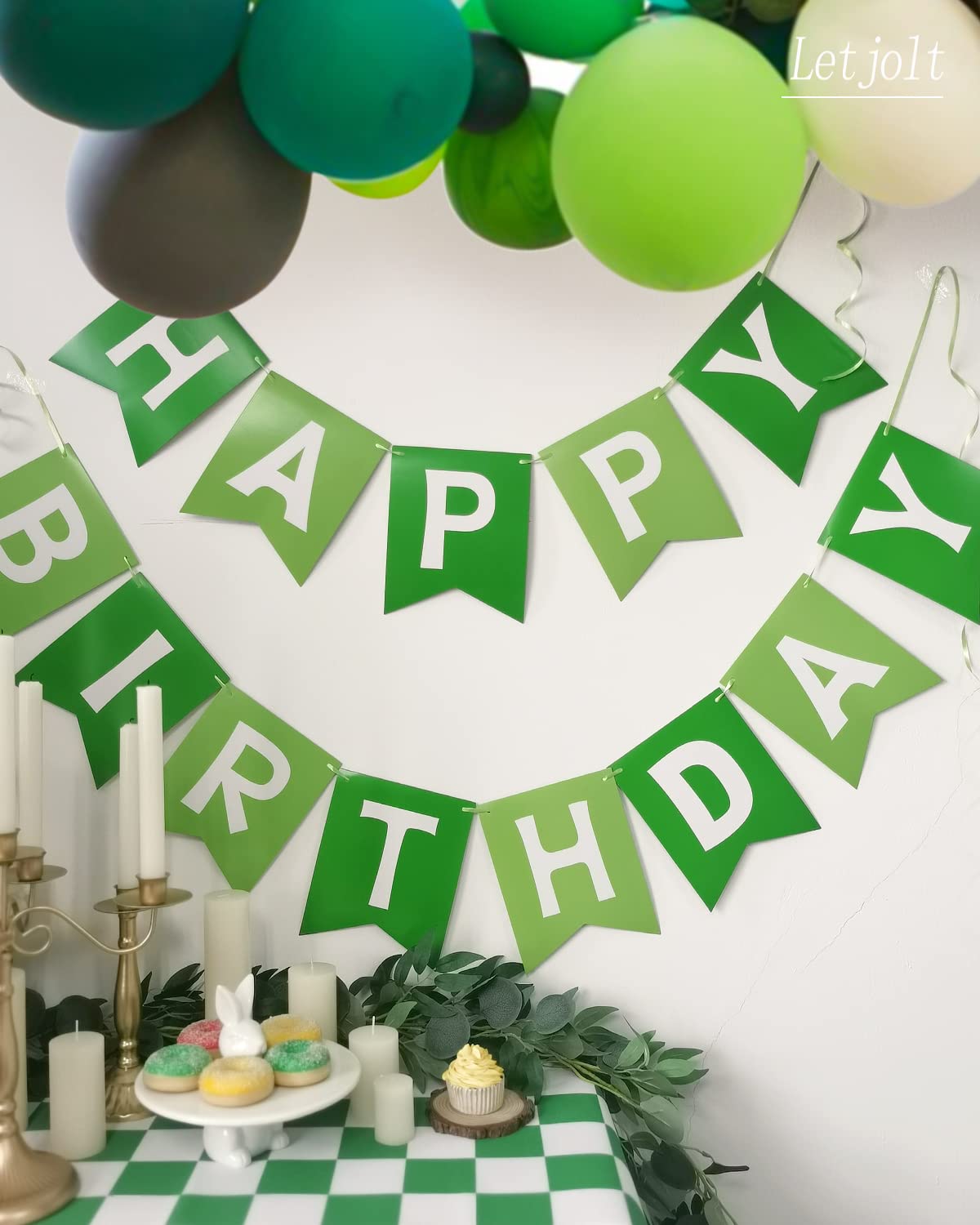 Letjolt greenery banner arranged on wall as nursery celebration backdrop