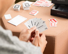 LIAR LIAR players guessing image shows friends laughing while guessing lies.