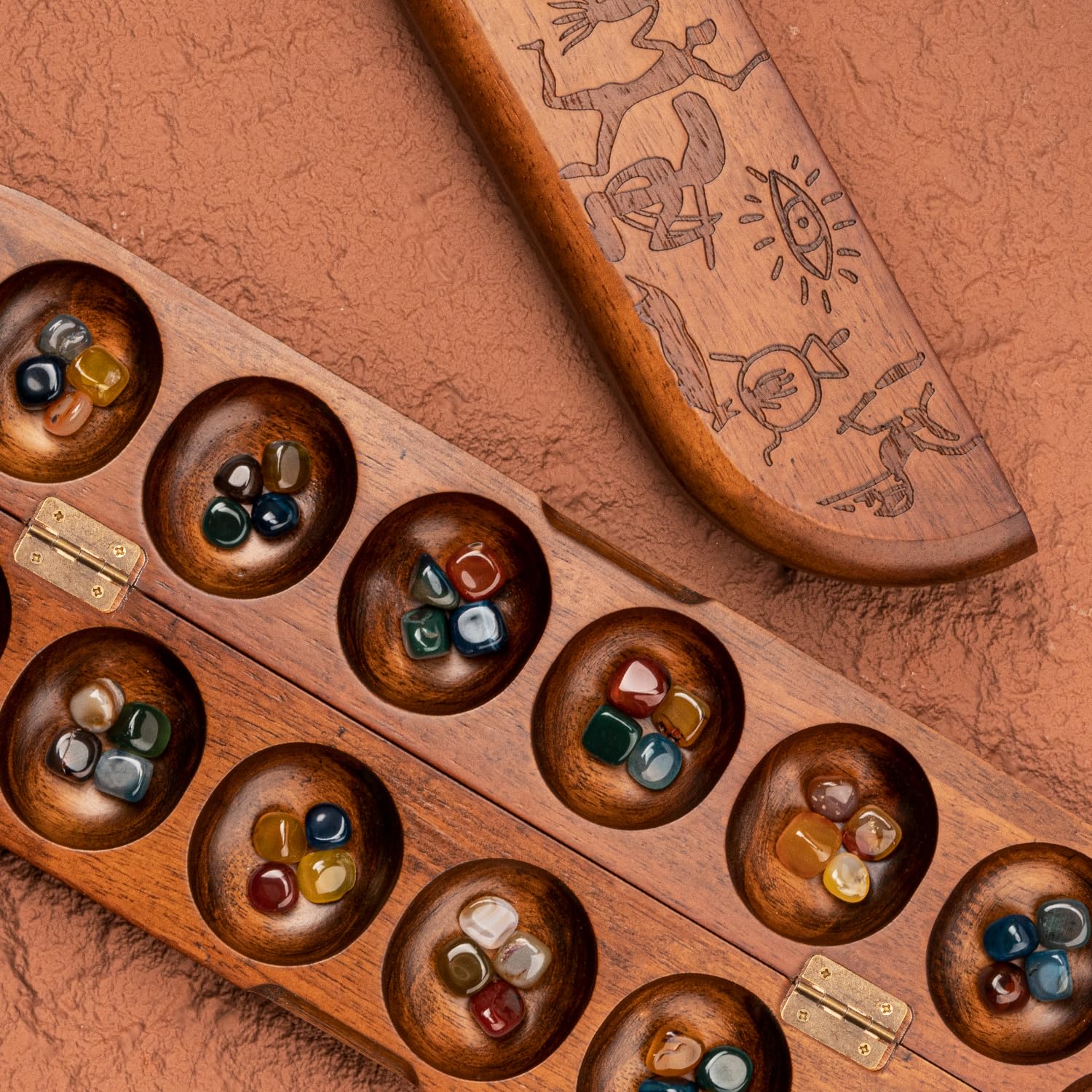 Lingle Deluxe Mancala board open showing authentic African petroglyphs.