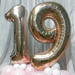 Lingqiang Champagne Gold Number 6 balloon deflated with straw for safe storage.