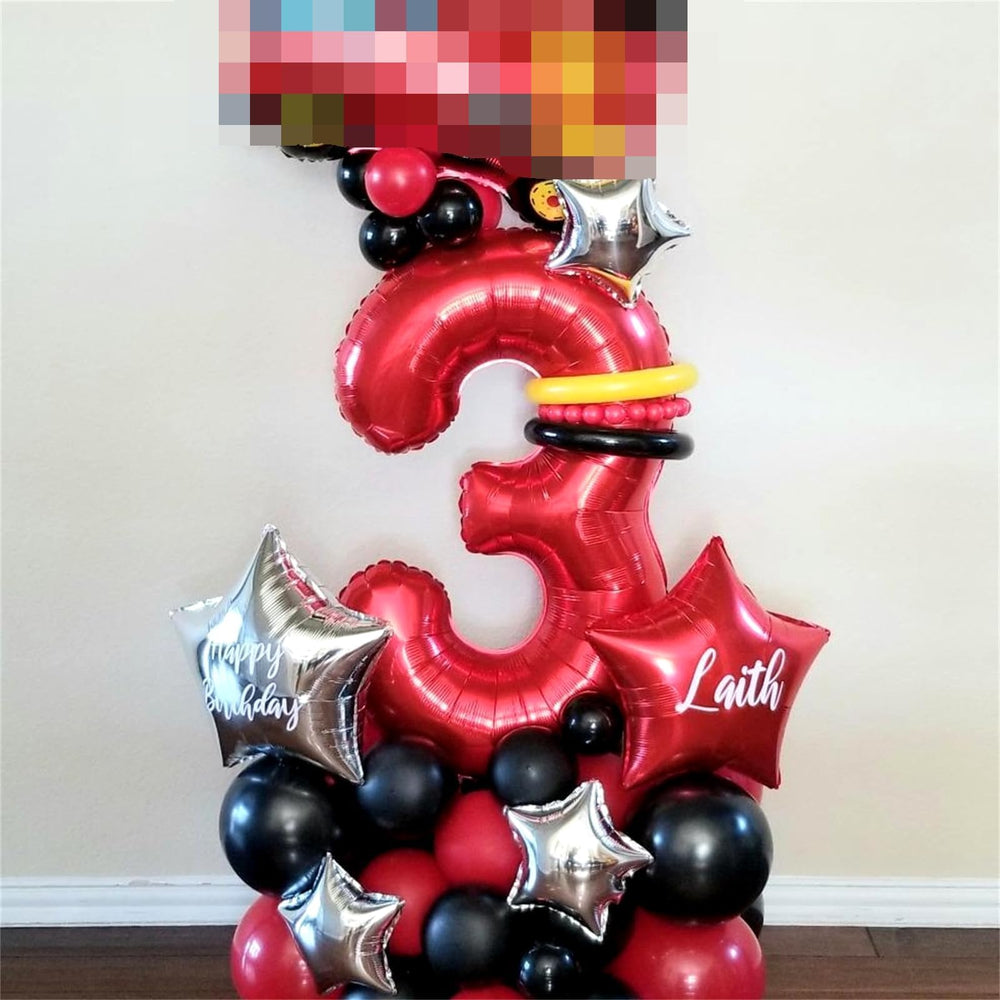 Lingqiang Red Number 1 balloon on a table with cake for celebrations.