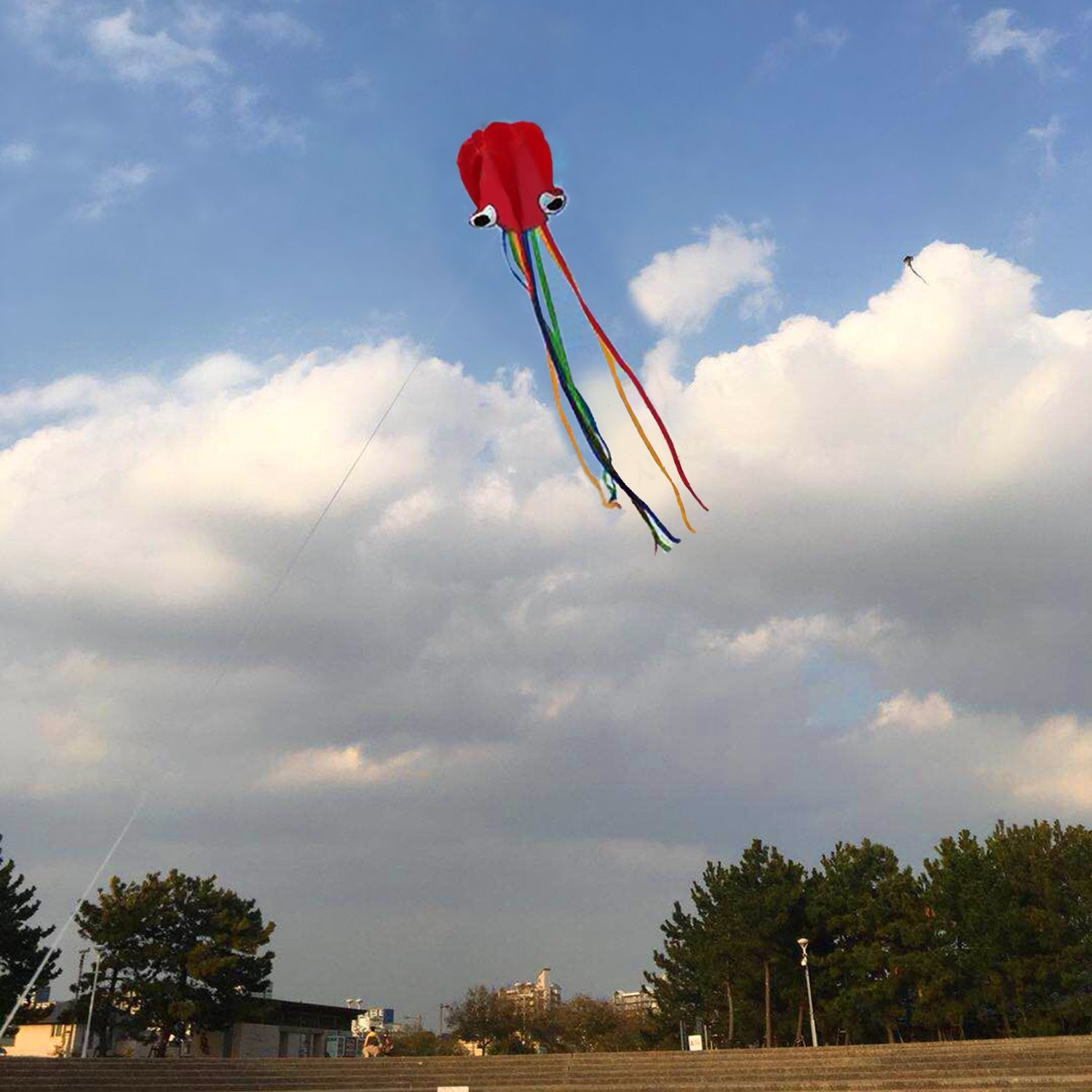 Listenman red mollusc octopus kite showing vibrant tail in breeze.